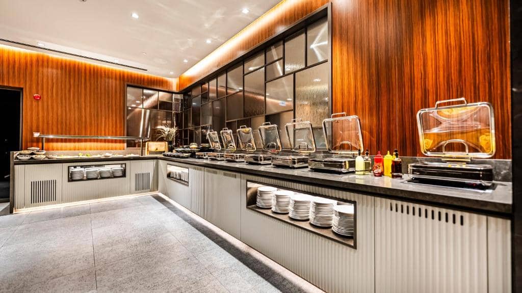 Lamartine Hotel - a restaurant kitchen with a counter with dishes at Lamartine Hotel in Istanbul