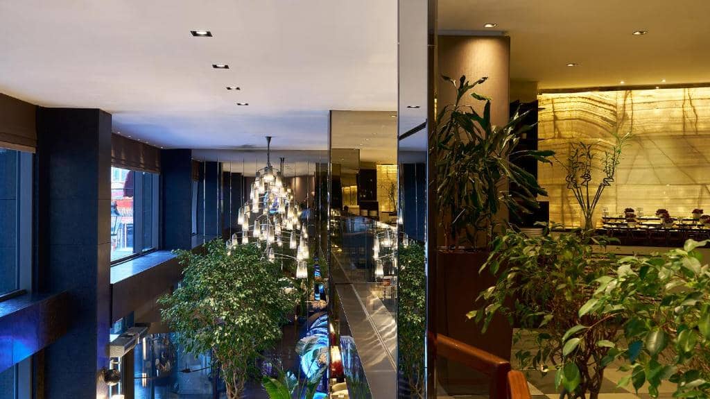 Lasagrada Hotel Istanbul - a lobby with plants and a building with a christmas tree at Lasagrada Hotel Istanbul in Istanbul