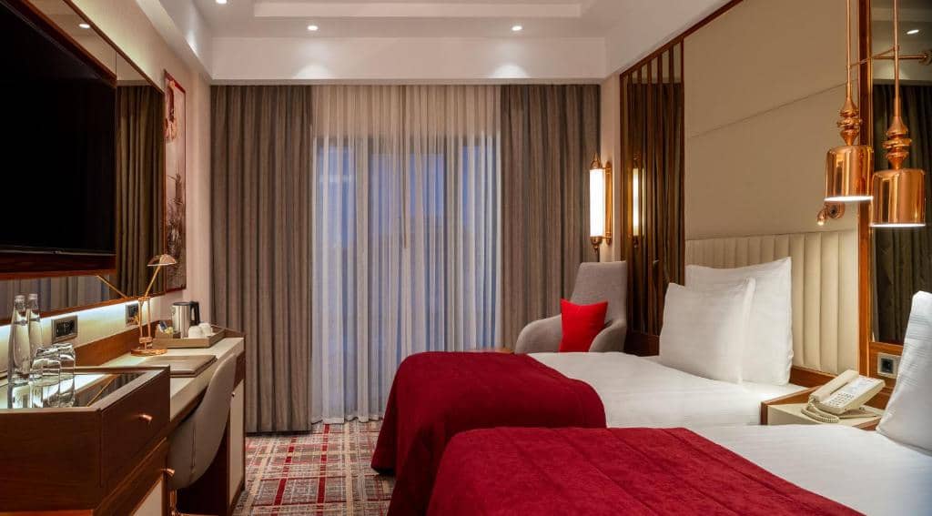 Mövenpick Hotel Istanbul Asia Airport - a hotel room with a bed and a sink at Mövenpick Hotel Istanbul Asia Airport in Istanbul