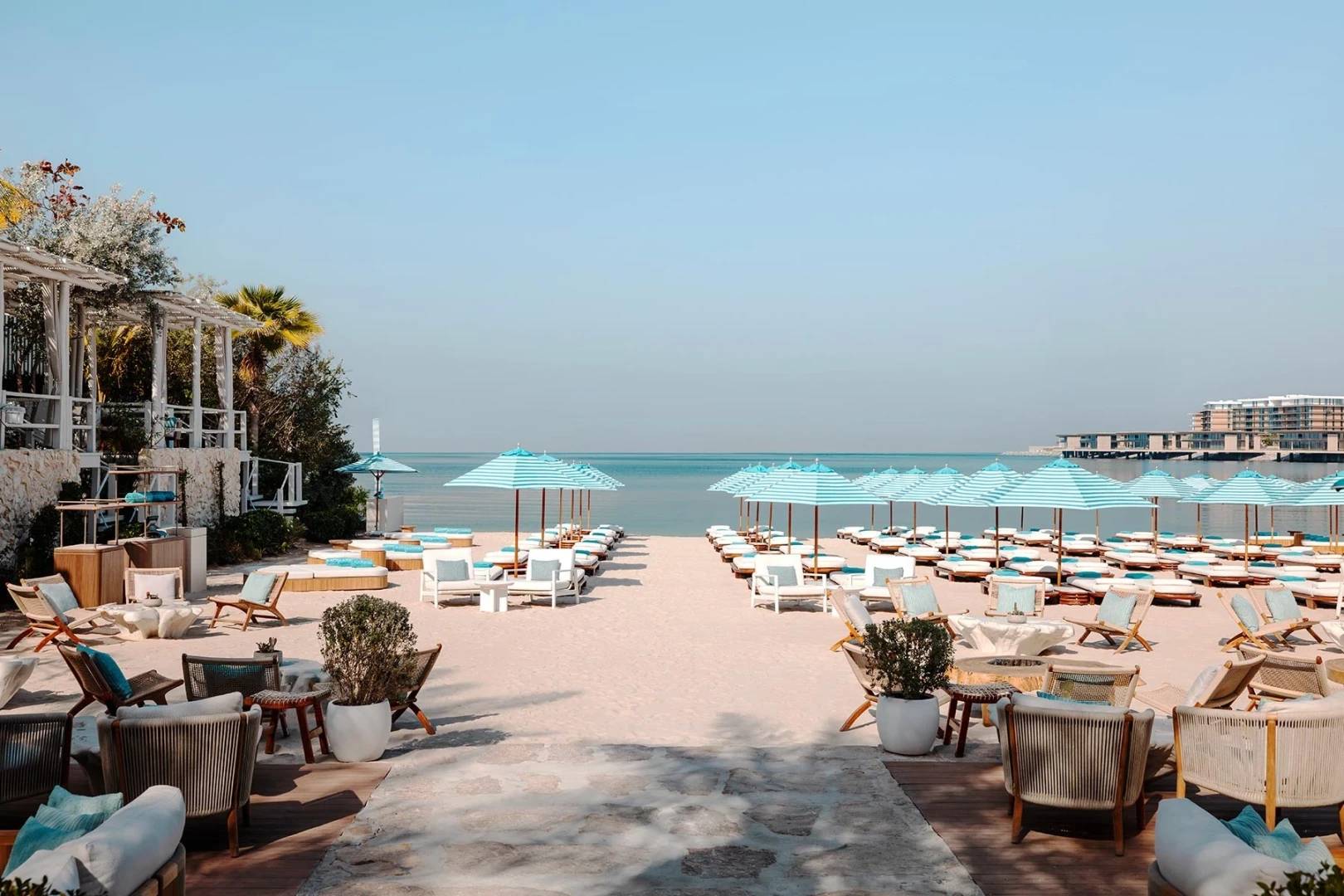 Nammos Dubai beachfront venue with umbrellas and seating, ideal for events.