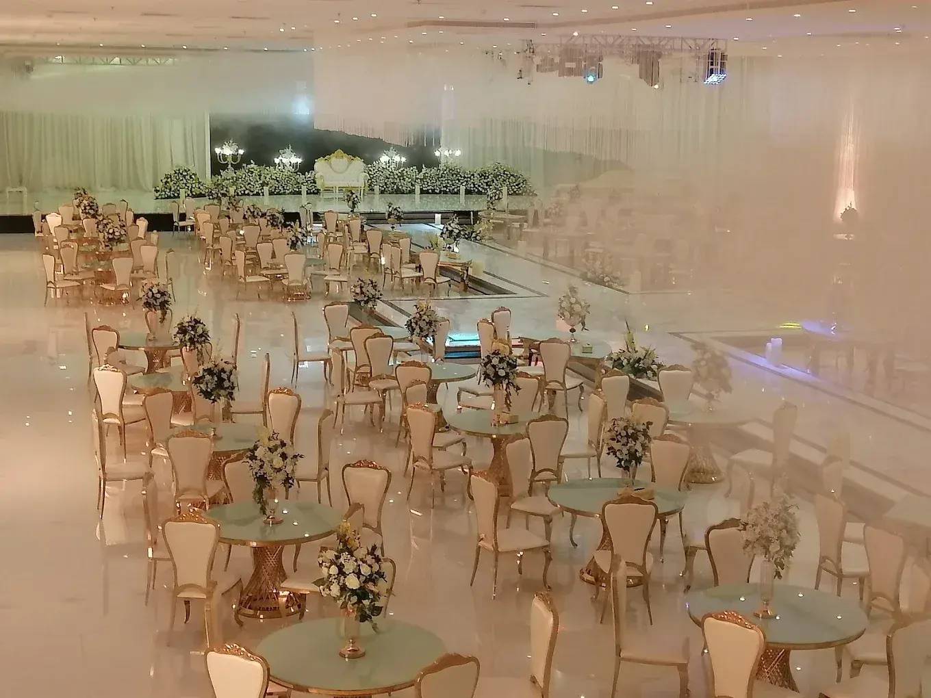 Elegant event setup with floral arrangements at Venice Wedding Hall Najran, Saudi Arabia.