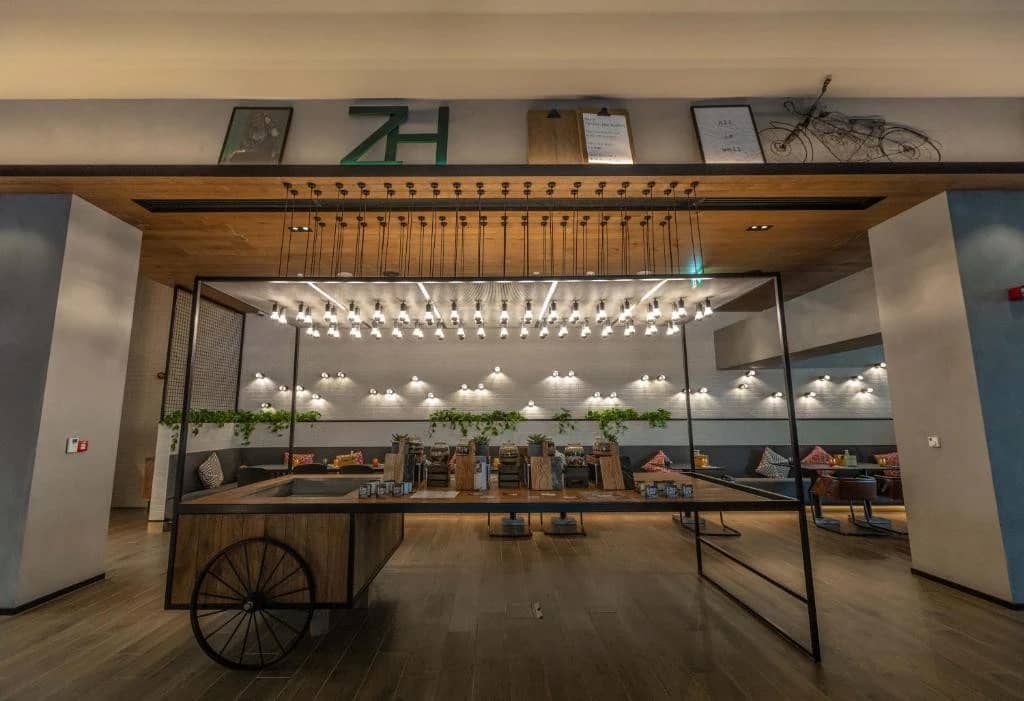 Modern interior of Zabeel House The Greens, Dubai, with hanging lights.
