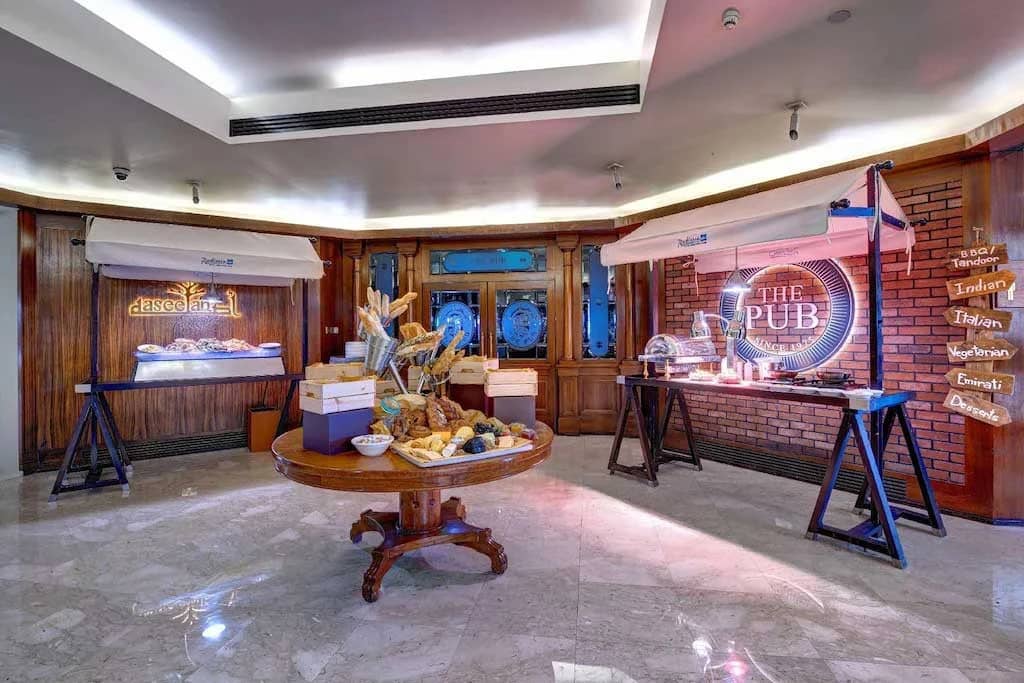 Radisson Blu Hotel Dubai buffet area with bread and food displays.