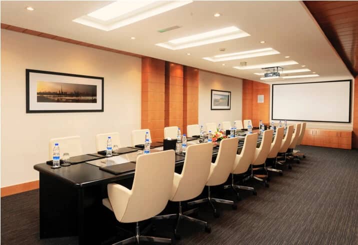Dubai World Trade Centre meeting room with projector and framed artwork.