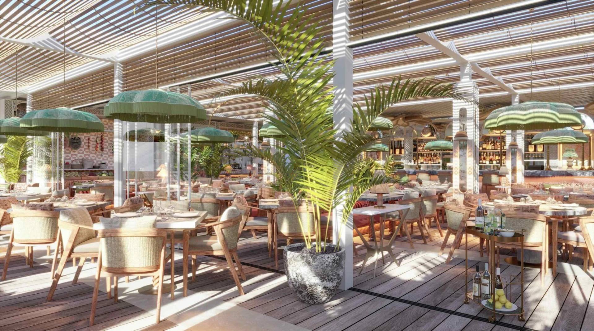 Maison de La Plage Dubai, elegant dining area with green umbrellas.