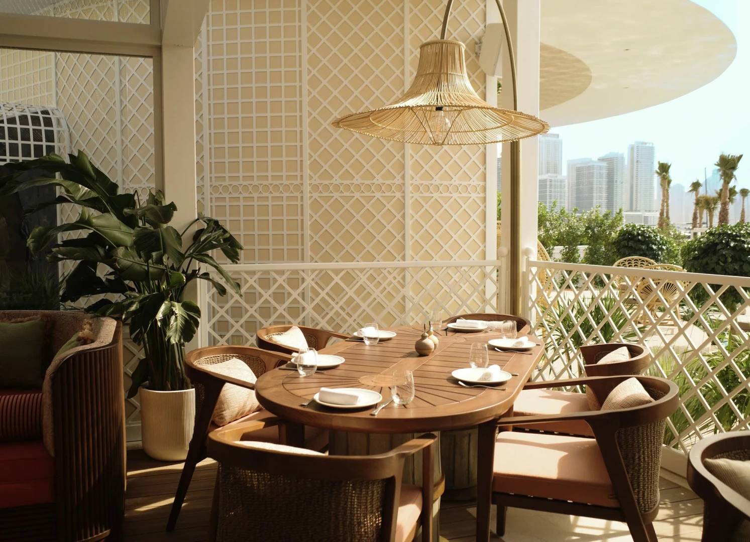 Maison de La Plage outdoor dining area, Dubai skyline view.