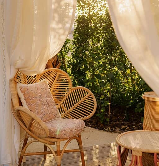 Cozy rattan seating area at Maison de La Plage, Dubai.