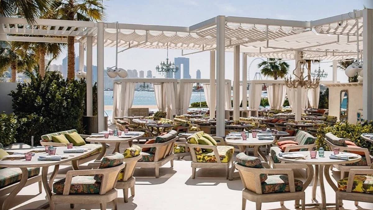 Outdoor dining area at Gallery 7/40 Dubai with waterfront view.
