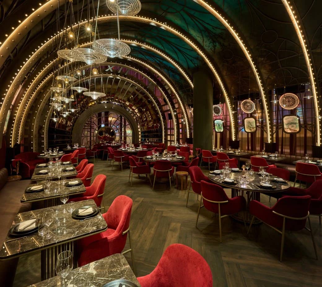 Elegant interior of Amelia Restaurant & Lounge, Dubai, with red seating.