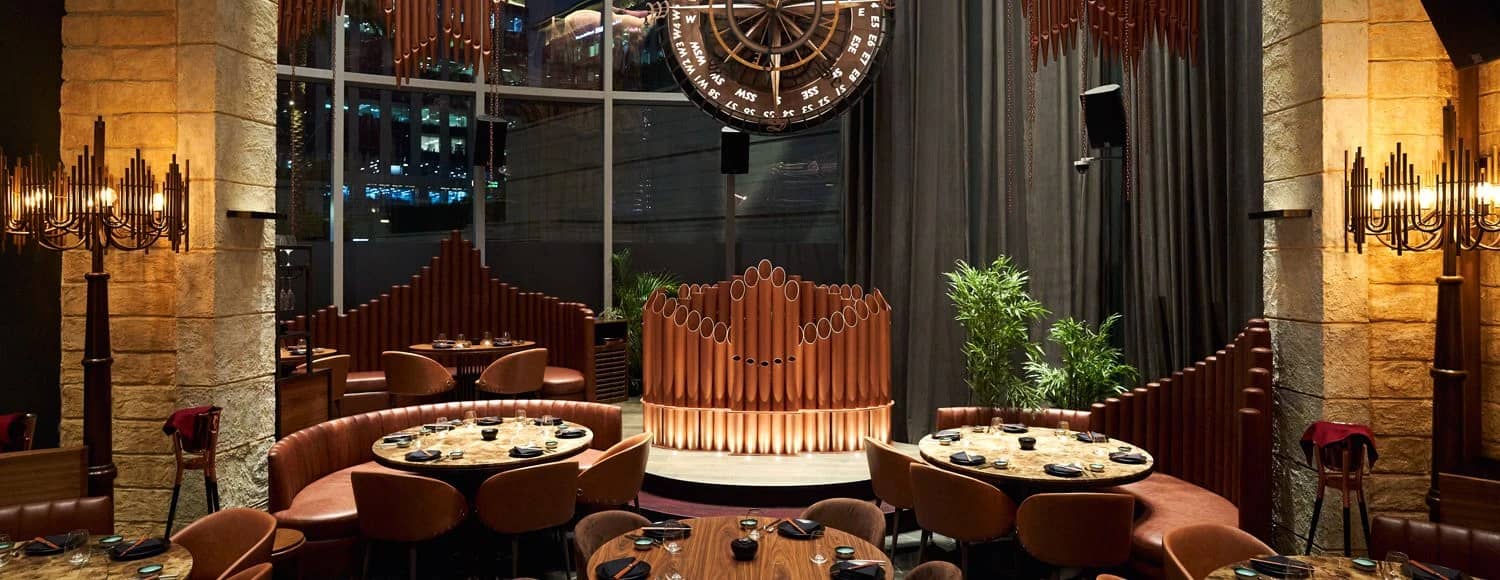 Cozy dining setup with circular tables at Amelia, Dubai.