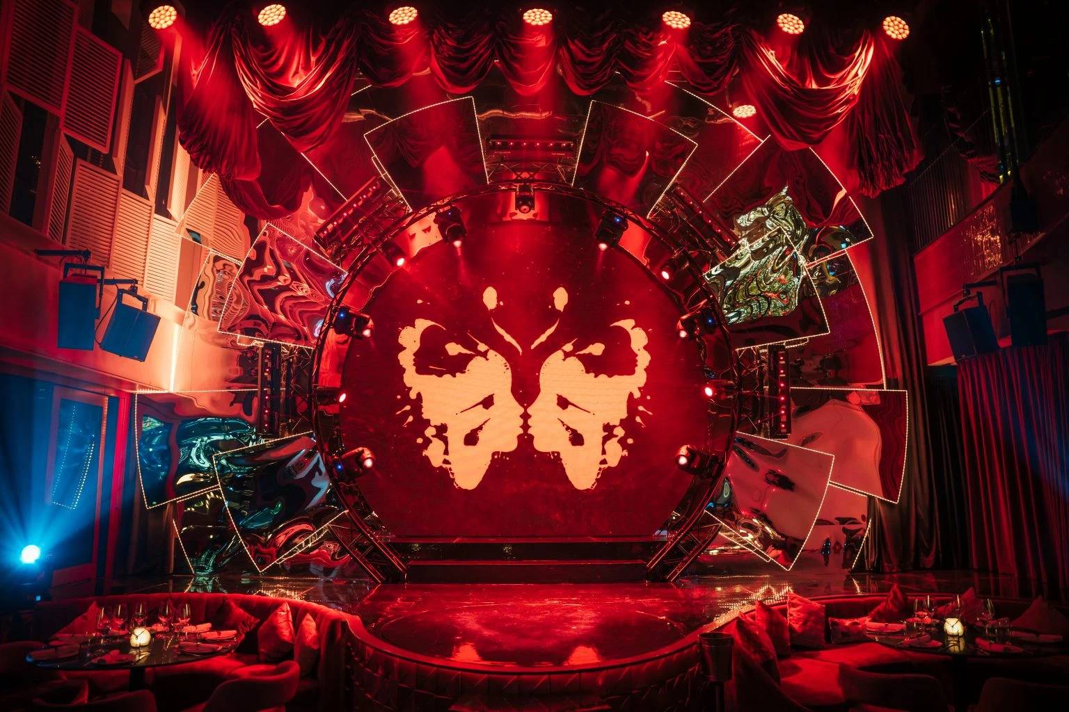 Babylon Difc Dubai stage with dramatic red lighting and decor.