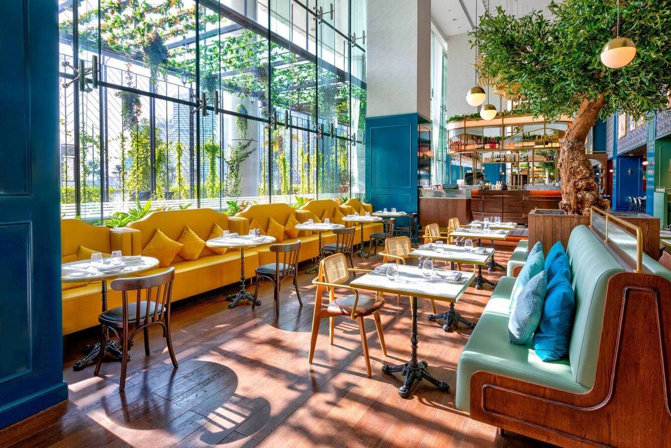 Couqley French Brasserie Downtown Dubai, elegant dining area with greenery.