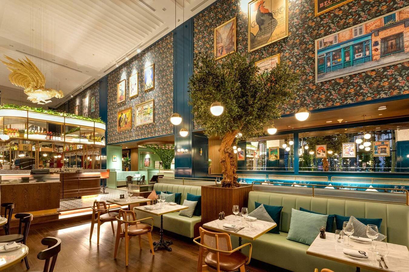 Chic Couqley Dubai dining room with tree and art-filled walls.