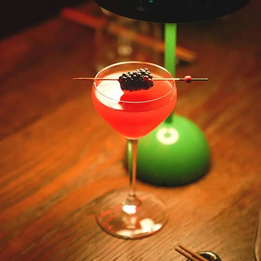 Cocktail with blackberry garnish at Hawkerboi, The Park JLT, Dubai.