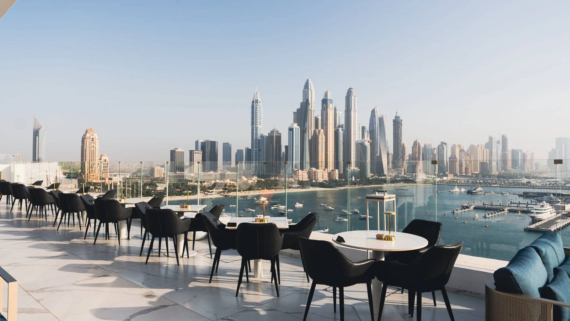 The Penthouse Dubai rooftop lounge with city skyline view.