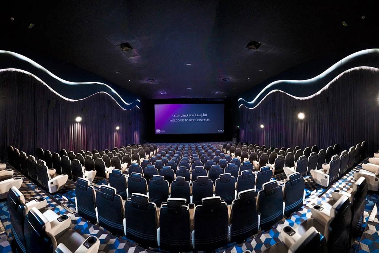 Spacious theater at Reel Cinemas, Dubai Marina Mall, with empty seats.