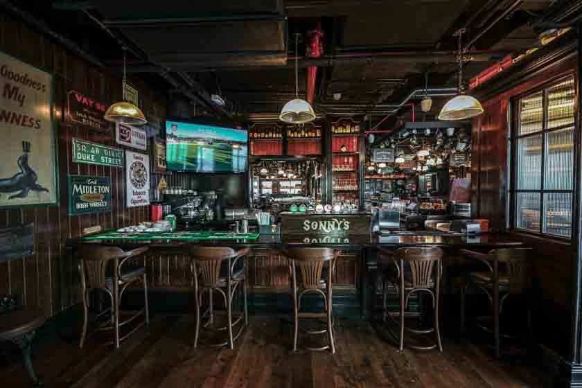 Cozy interior of McCafferty's Pub Jumeirah Village, Dubai with wooden decor.