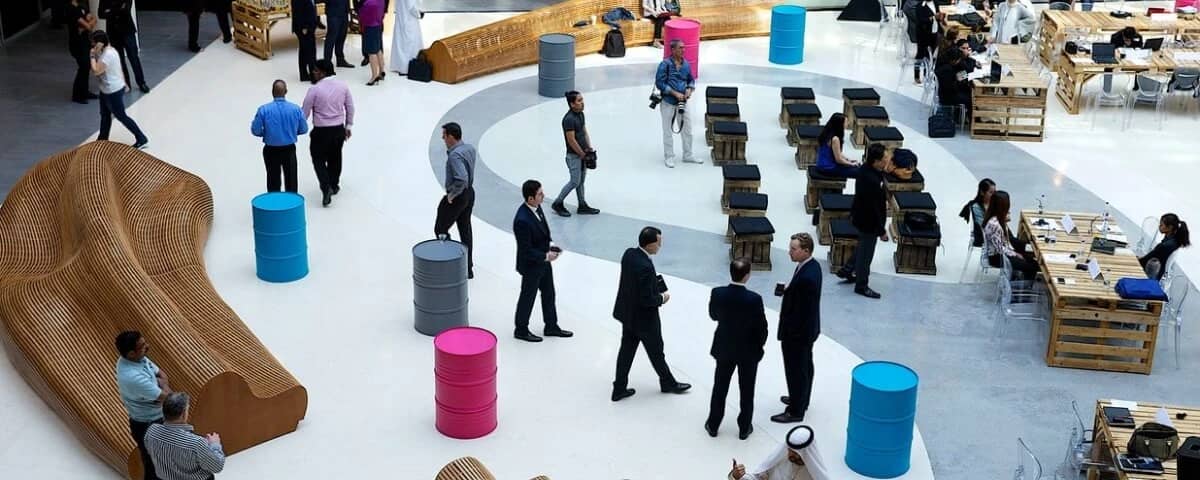 People networking in D3 Dubai Design District atrium.