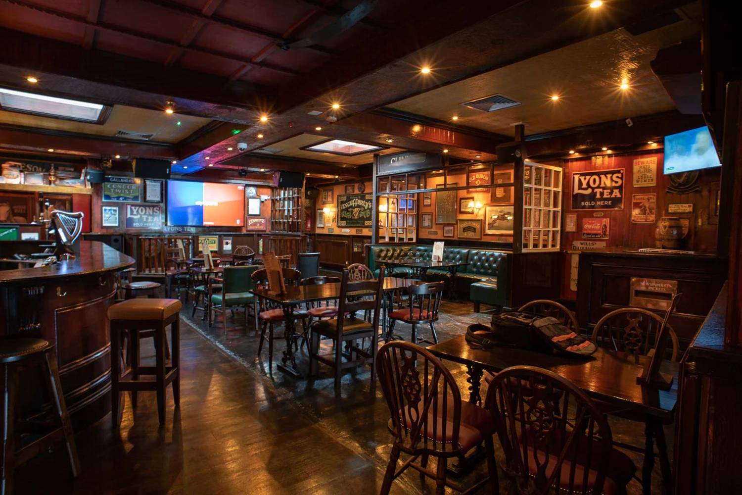 Rustic pub interior with vintage signs and wooden furnishings, Dubai.