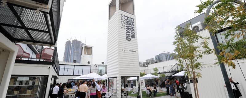 Outdoor event at D3 Dubai Design District with people and seating.