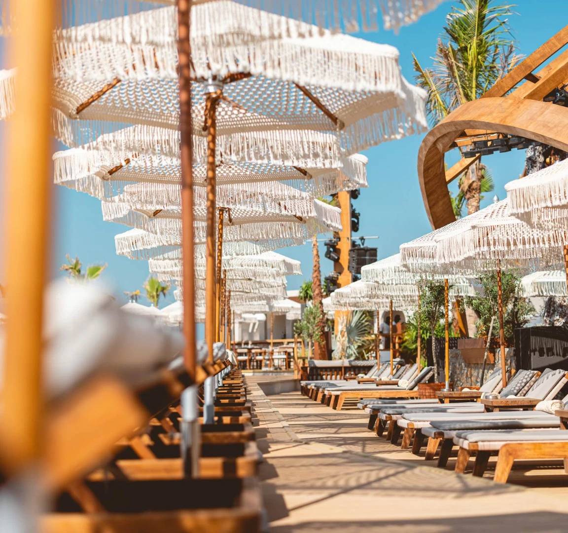 Stylish beachside loungers and umbrellas at Be Beach DXB, Dubai.