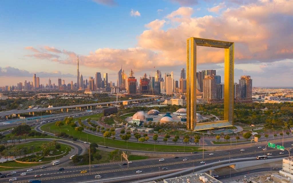 Zabeel Park with Dubai skyline and iconic frame structure.