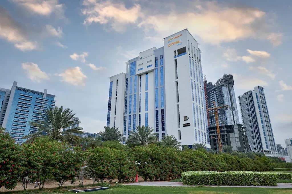Citymax Hotel Business Bay skyscraper in Dubai with cloudy sky.