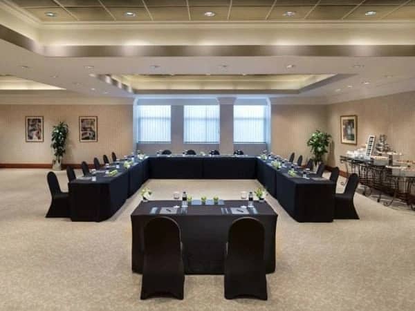 Elegant conference room at Kempinski Hotel Ajman with U-shaped table setup.