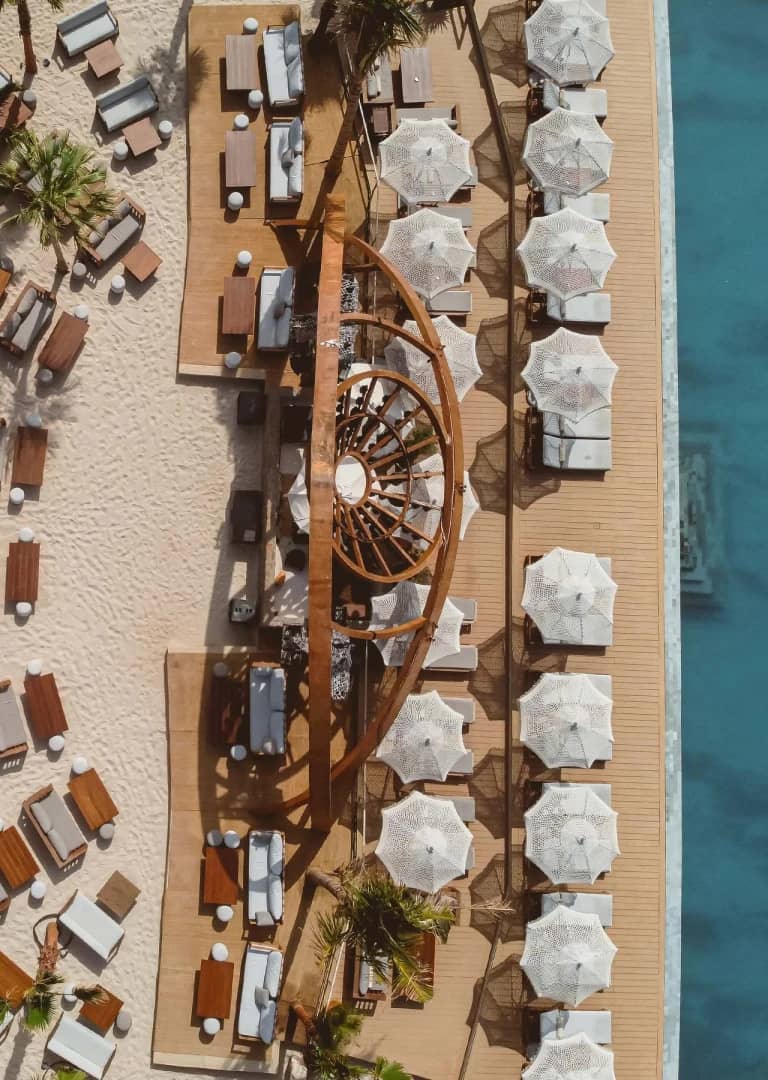 Aerial view of Be Beach DXB with umbrellas and seating, Dubai.