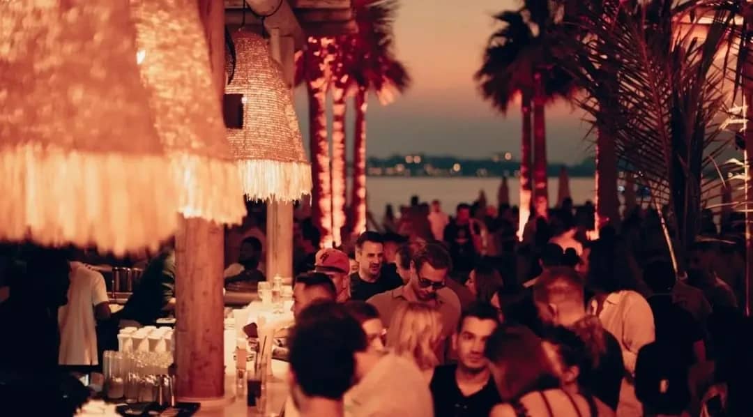 Crowded evening at Surf Club Dubai with beachside ambiance.