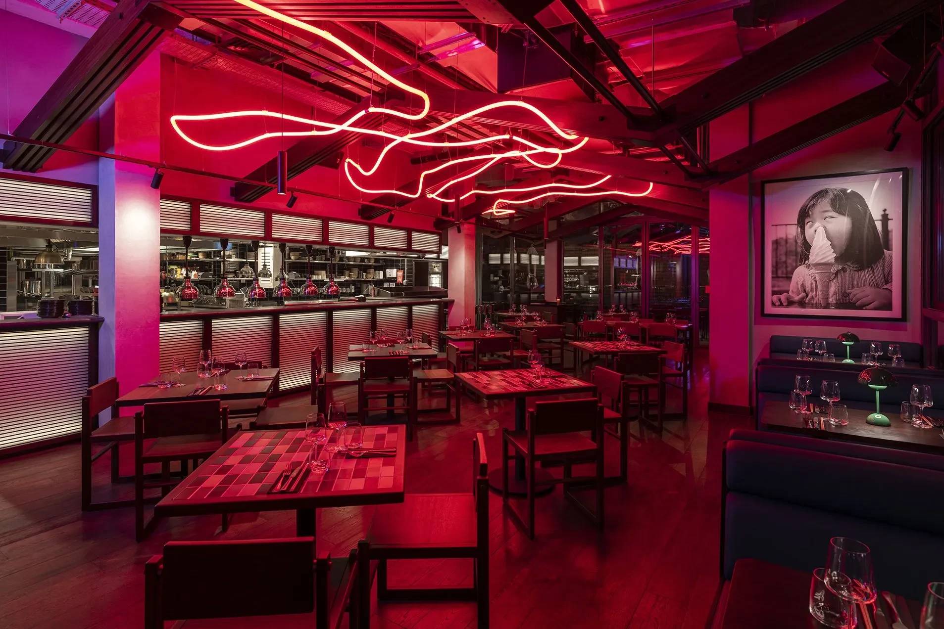 Hawkerboi restaurant interior with red lighting, Dubai.