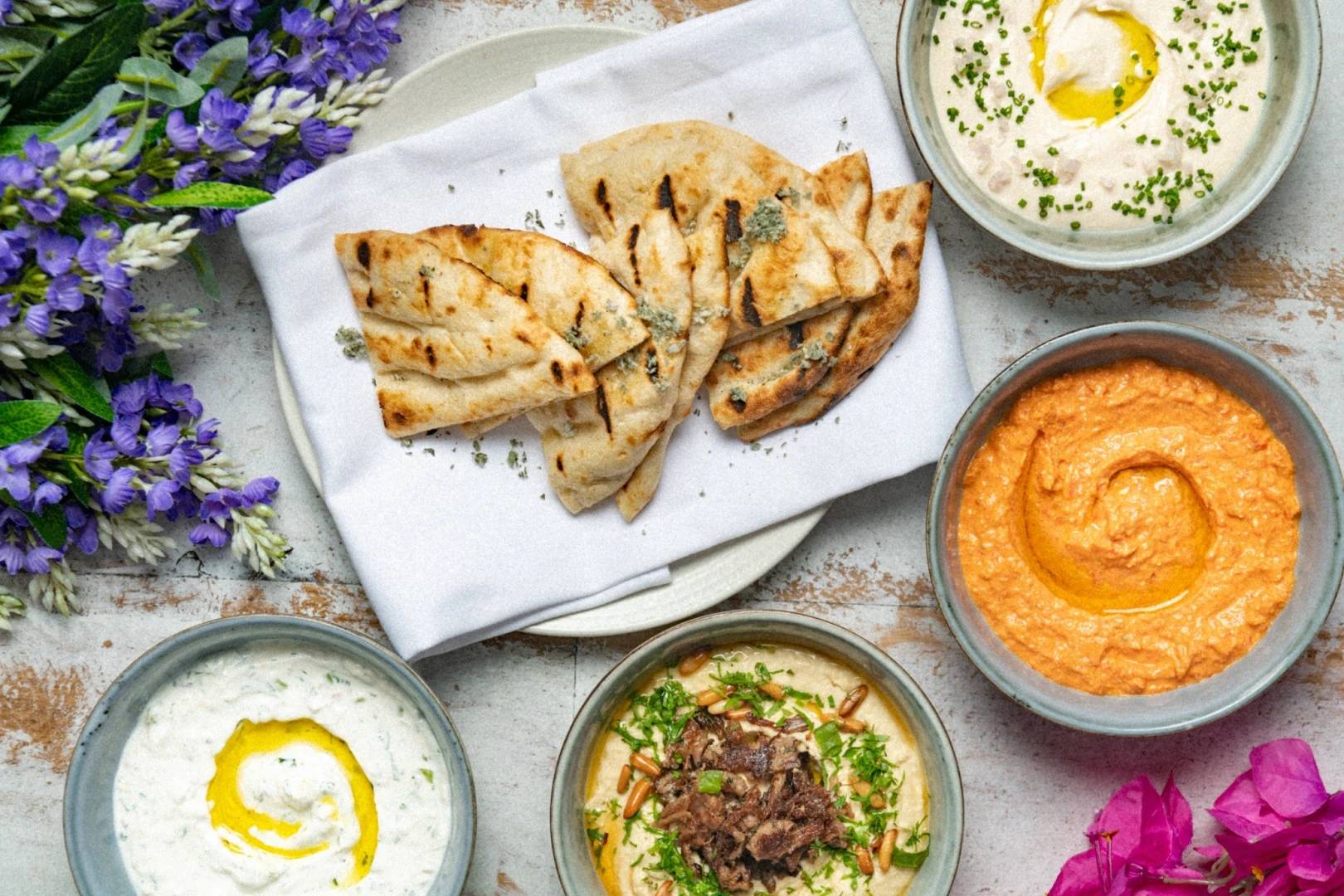 Pita bread with assorted dips at Opa Dubai, Dubai.