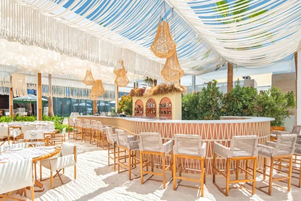 EVA Beach Restaurant's outdoor bar with woven decor, Dubai.