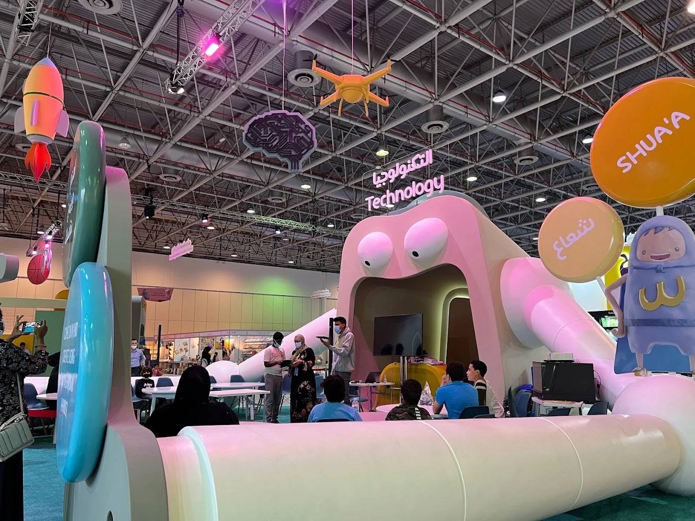 Expo Centre Sharjah technology exhibit with colorful decorations and visitors.