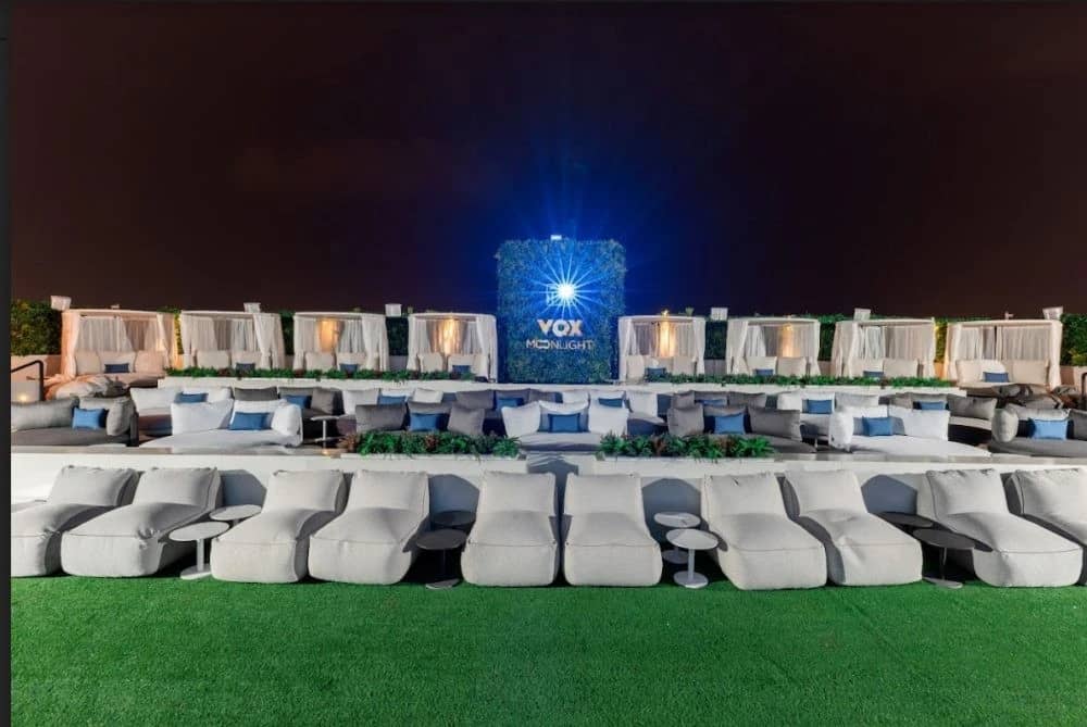 Outdoor seating at VOX Moonlight, Dubai, under night sky.