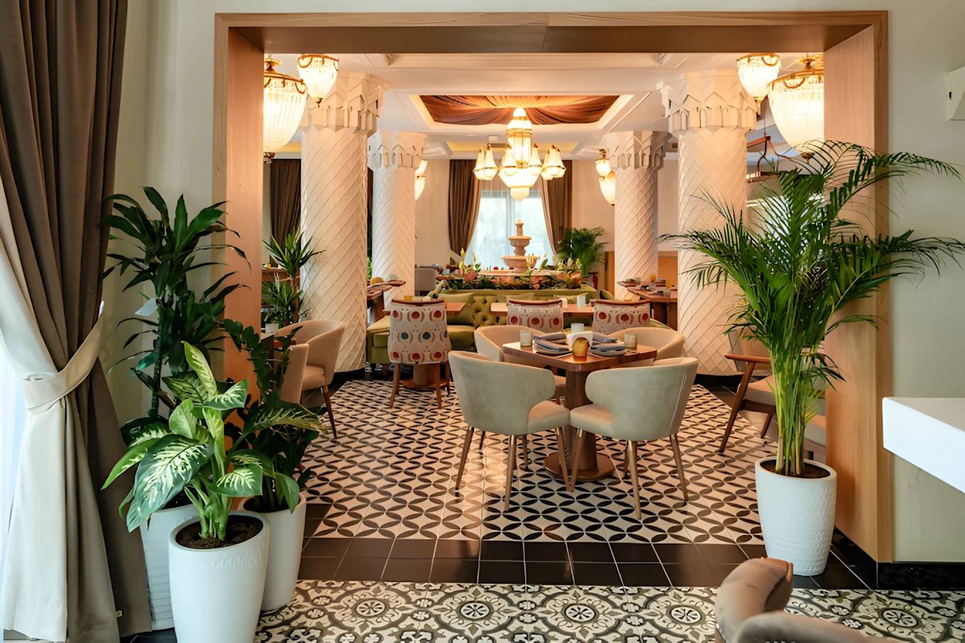 Elegant dining area at Grand Zor Restaurant, Dubai with lush plants.