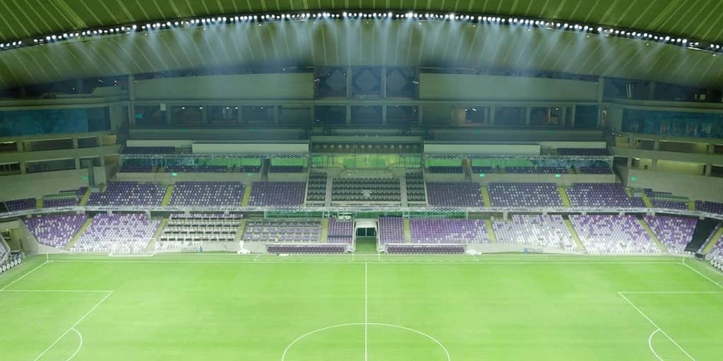 Empty Hazza Bin Zayed Stadium with green field, Al Ain.