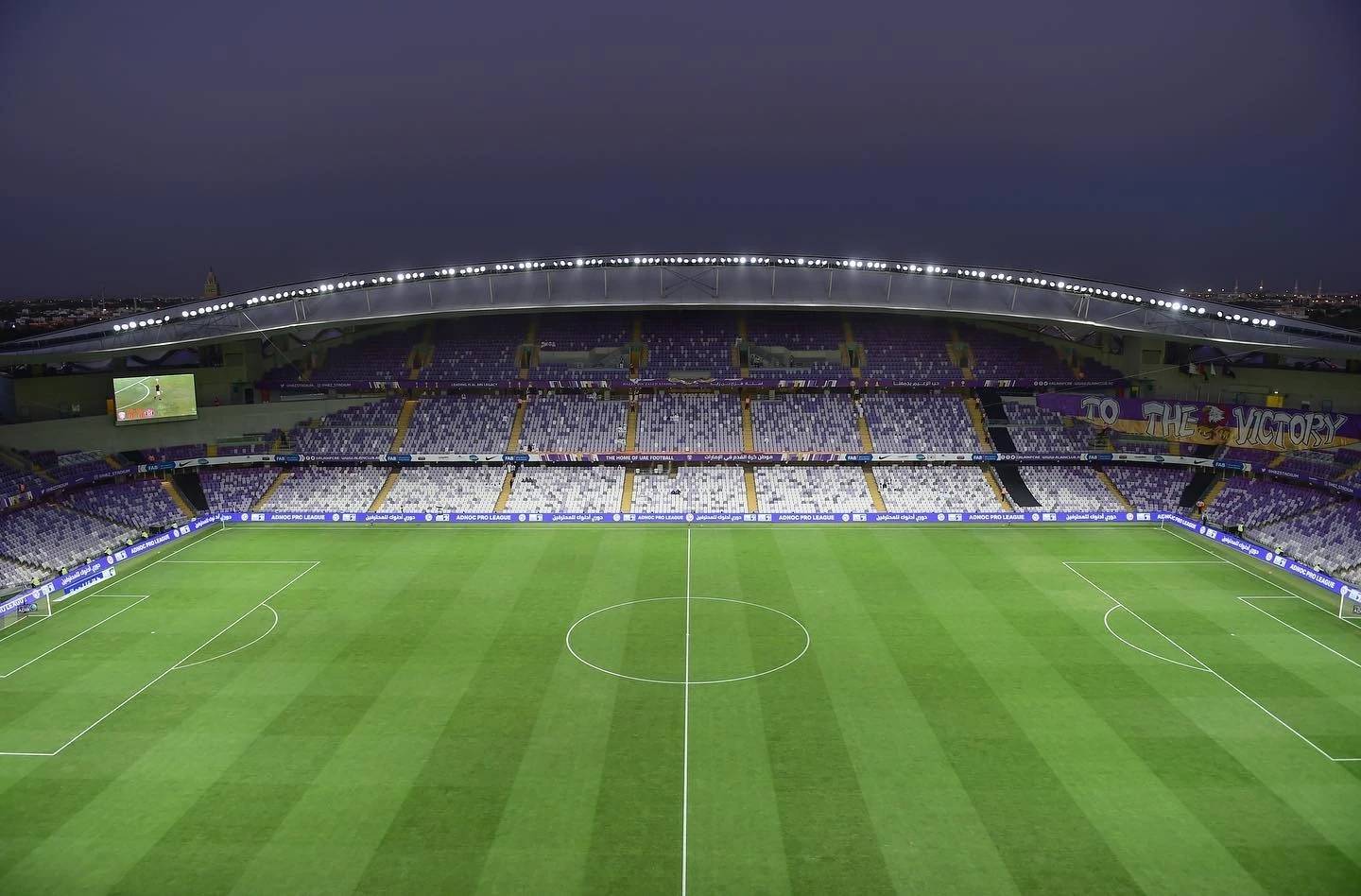 Empty Hazza Bin Zayed Stadium in Al Ain at dusk.