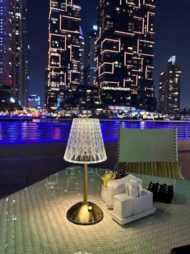 Elegant table setting at ILOLI, Dubai Marina Walk, night skyline view.
