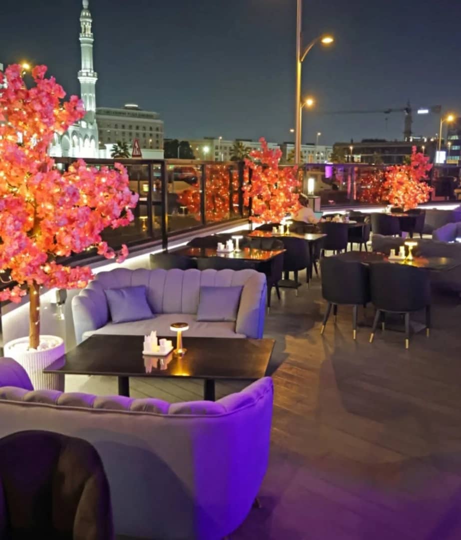 KUKU Restaurant Dubai terrace with pink illuminated trees at night.