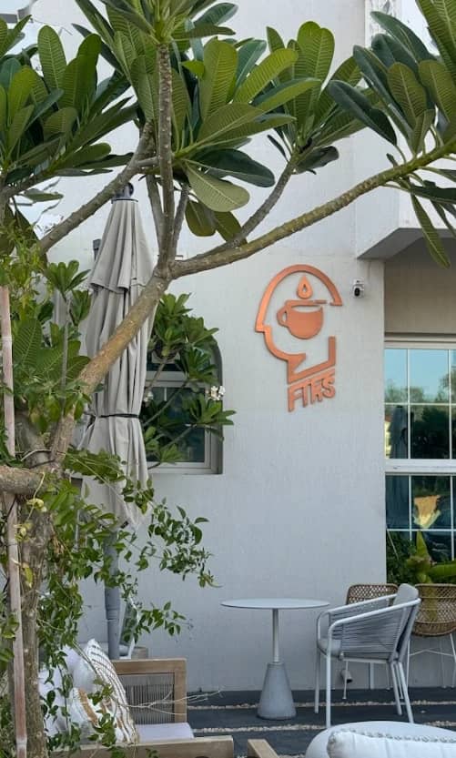 Outdoor seating at Fiks Coffee Umm Suqeim, Dubai with greenery.