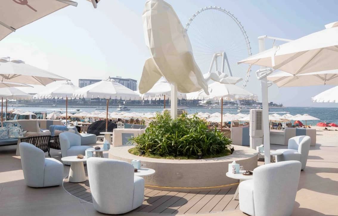 Yula Lounge outdoor seating with Dubai Ferris wheel view.