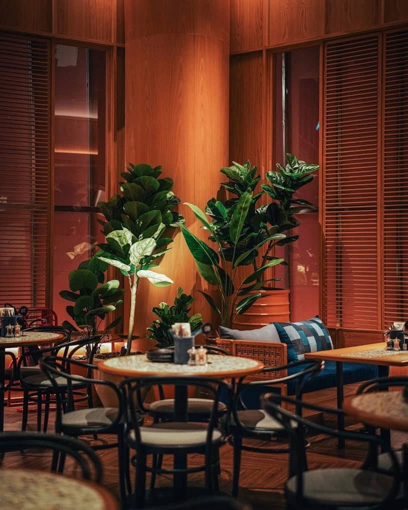 Cozy dining area with plants, Social House Restaurant Dubai.