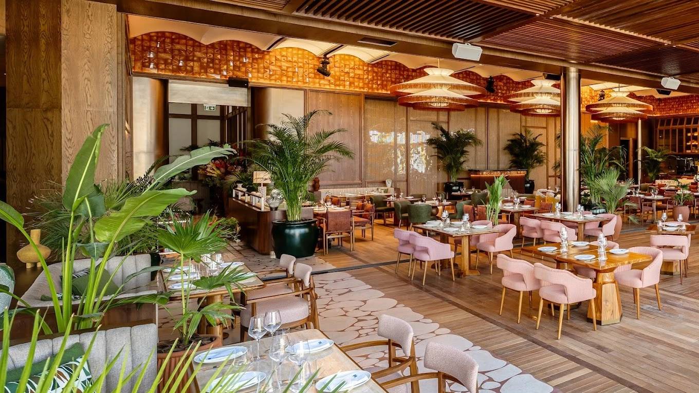 Elegant dining area at Baoli Restaurant Dubai with lush greenery.