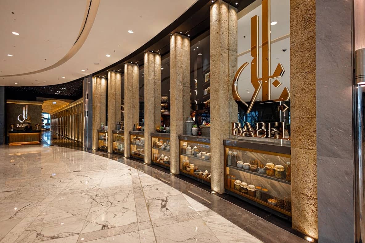 Elegant entrance of Babel Dubai Restaurant Downtown with decorative columns.