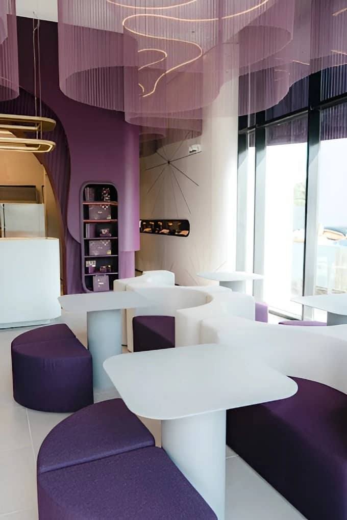 Modern interior of Myra Cafe Jeddah with purple and white decor.
