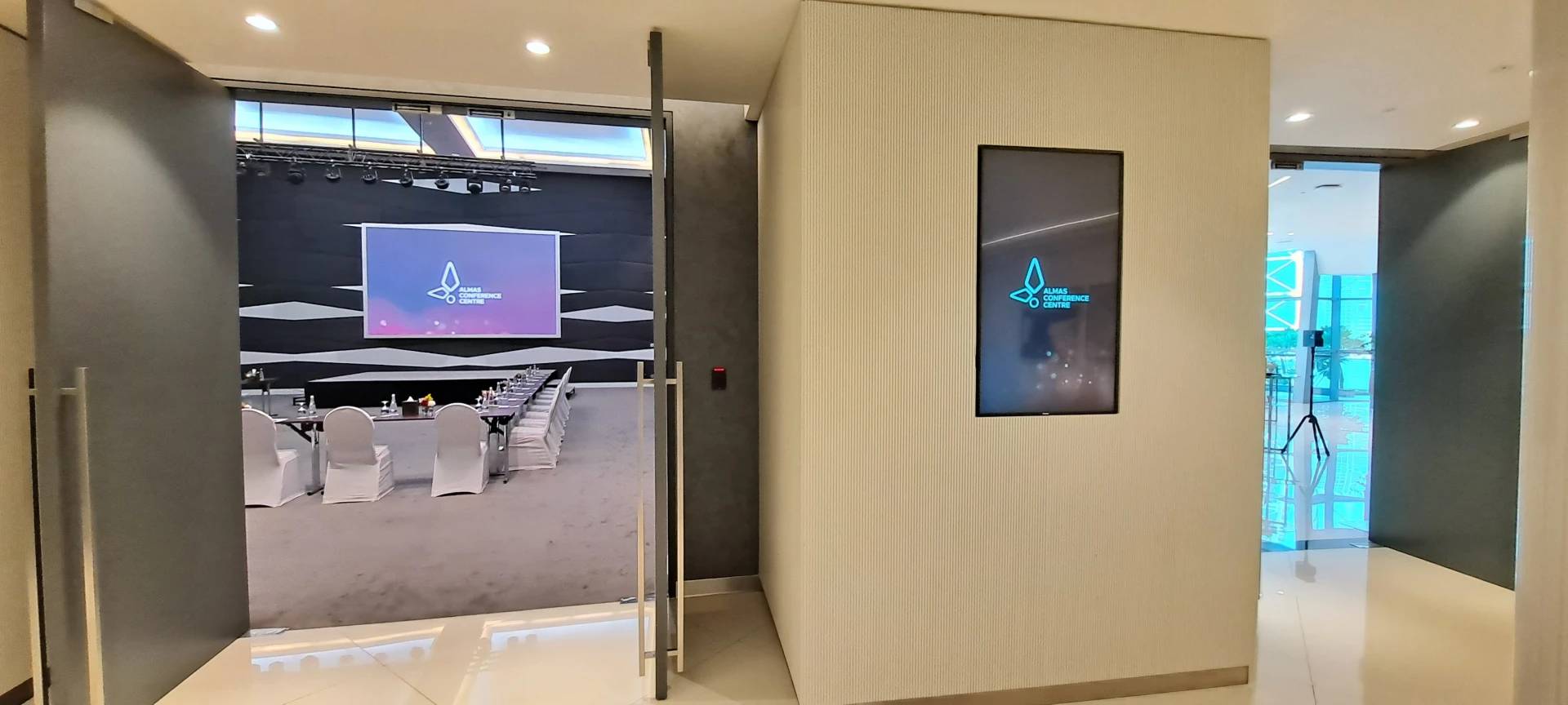 Entrance to Almas Conference Centre, Dubai, with modern interior design.