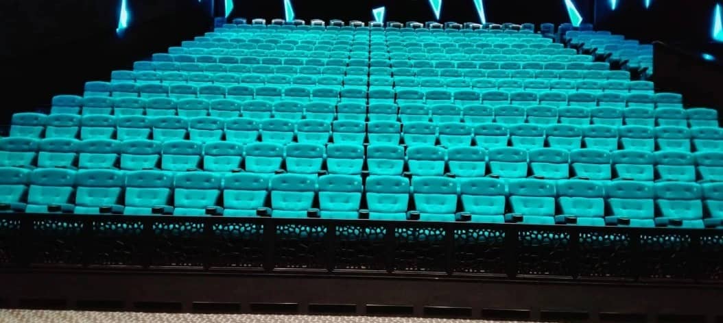 Empty auditorium with teal seats at Novo Cinemas Msheireb Doha.