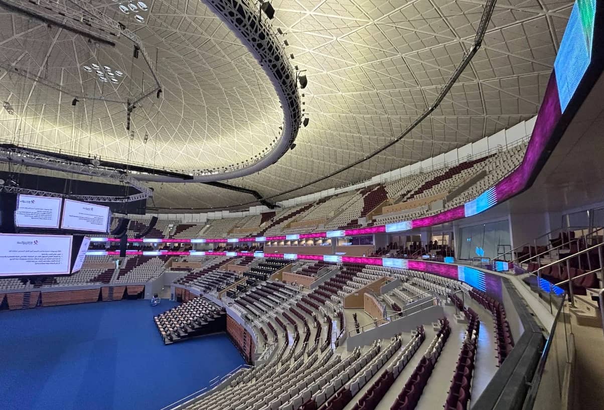 Interior of Lusail Multipurpose Hall, Doha, with seating and screens.