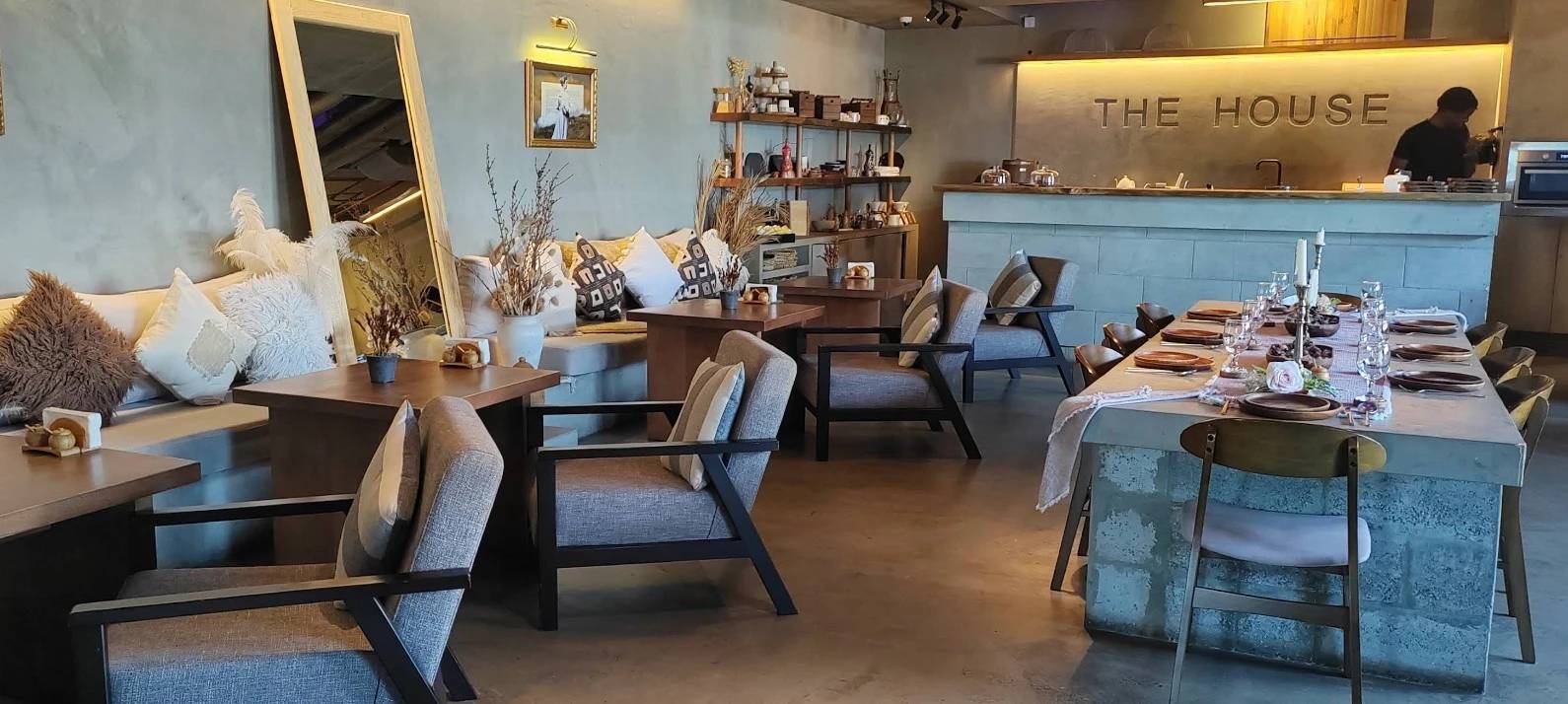 Cozy interior of The House Restaurant Lusail with elegant table setting.